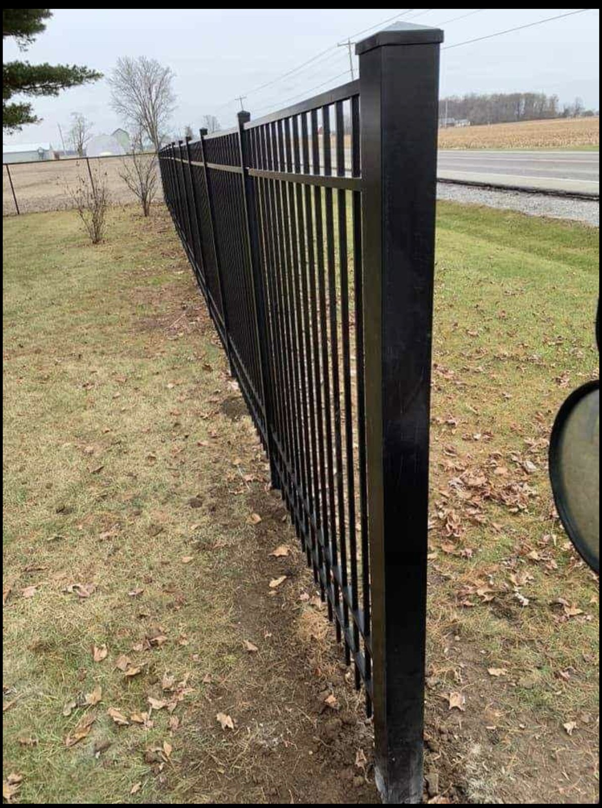 Black metal fencing: A closer look at the posts and pickets.